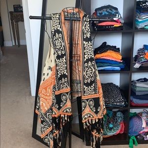 Sleeveless orange and black fringe vest